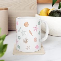 a white coffee mug sitting on top of a counter