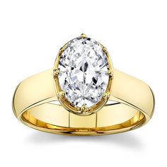 a yellow gold ring with an oval cut diamond