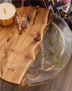 a wooden table that has some plants on it and an object in the middle with sticks sticking out of it