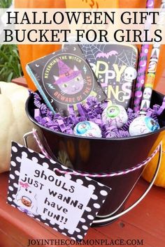 a bucket filled with halloween gifts for girls