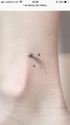 a small star tattoo on the side of a woman's right ribcage