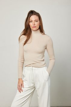 Your wardrobe staple is the Nicole Cashmere Turtleneck in Oyster. Lightweight and super soft, this sweater will pair with all of your elevated essentials. Shown here in a size Medium. 100% cashmere Dry Clean Only Beige Cashmere Tops For Fall, Neutral Long Sleeve Cashmere Sweater, Classic Spring Turtleneck Sweater, Classic Turtleneck Sweater For Spring, Elegant Fine Knit Polo Sweater For Spring, Elegant Cream Polo Sweater For Fall, Classic Cashmere Sweater In Neutral Color, Beige Merino Wool Top For Fall, Fall Beige Merino Wool Tops