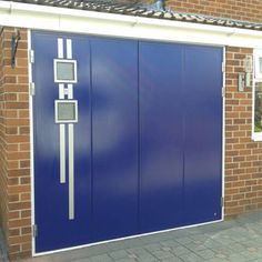 a large blue garage door on the side of a brick building