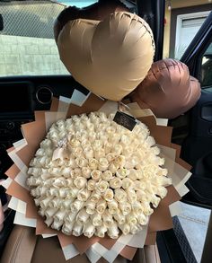 a bunch of fake flowers in the back seat of a car