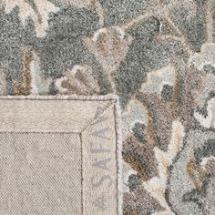 a close up view of the corner of a rug with an image of flowers on it