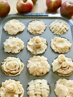 twelve apple pies are sitting on a baking tray