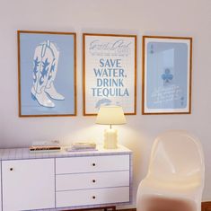 a white chair sitting next to a lamp on top of a wooden table in a room