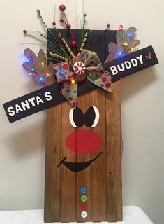 a christmas decoration made out of wood with lights on it's head and the words santa's buddy