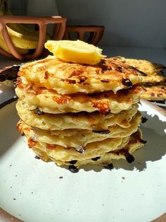 a stack of pancakes sitting on top of a white plate