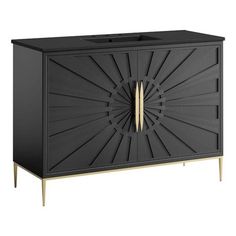 a black cabinet with gold handles and an intricate design on the front, it has a wooden