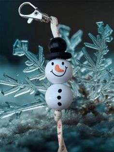 a snowman ornament hanging from a key chain