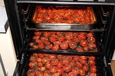 an open oven with several trays of food cooking in it and on top of each other