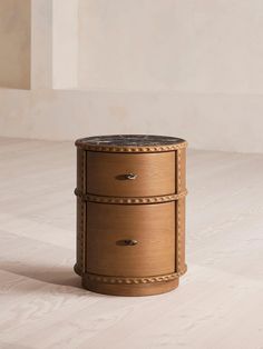 a round wooden table with two drawers