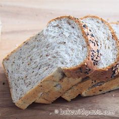 three slices of bread sitting on top of a wooden cutting board