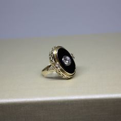 Formal Oval 14k Gold Enamel Ring, Oval 14k Gold Enamel Ring For Formal Occasions, Black Oval Cluster Ring For Anniversary, Formal Oval Enamel Ring In 14k Gold, 14k Gold Oval Enamel Ring For Formal Occasions, Black Enamel Diamond Anniversary Ring, Round Black Enamel Diamond Ring For Anniversary, Classic Formal Enamel Round Ring, Vintage Round Diamond Enamel Ring