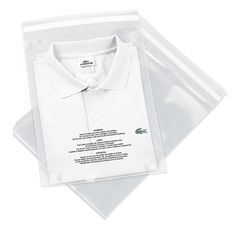 a white shirt in a clear plastic bag on top of a piece of paper with the label