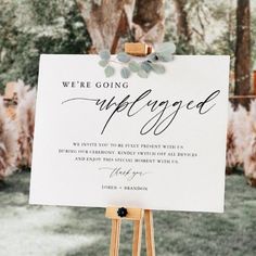 a sign that says we're going engaged on the side of a wooden easel