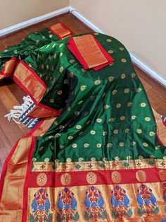 Roopayan Boutique presents a gorgeous pure silk Paithani saree straight from the Western part of India. It is an evergreen & beautiful green & red color pure paithani silk saree with an all-over peacock buttas & zari woven border, perfect for any special occasion. It has a very rich peacock woven pallu. Roopayan Boutique specializes in exclusive designer and traditional sarees from different parts of India. Our 20 years of experience in the business promises you the richest quality clothing at a