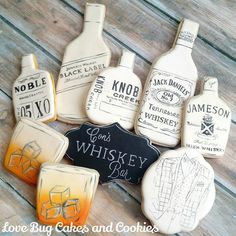 decorated cookies are arranged in the shape of whiskey bottles