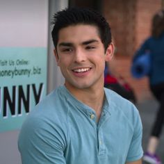 a young man is smiling for the camera