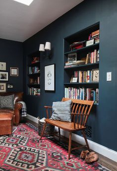 a living room filled with furniture and bookshelves next to a wall mounted book shelf