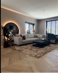 a modern living room with white couches and black coffee table