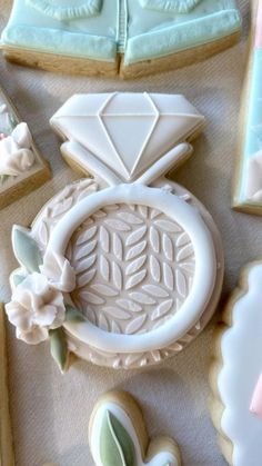 decorated cookies and cookie cutters on a table