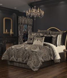 a large bed in a room with a chandelier