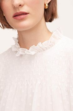 Accented with ruffled and smocked detailing, our feminine clip dot chiffon blouse is at once timeless and timely. Feminine Blouse With Smocked Bodice And Ruffle Sleeves, White Feminine Smocked Top With Ruffles, Feminine White Smocked Top With Ruffles, Feminine Smocked Top With Ruffle Hem, Feminine Ruffle Sleeve Tops With Smocked Cuffs, Chic Smocked Top With Ruffles For Daywear, Elegant Top With Smocked Back And Ruffle Sleeves, Elegant Spring Smocked Top With Ruffles, Feminine Ruffle Sleeve Blouse With Smocked Back