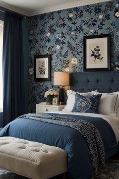 a bedroom with blue wallpaper and white bedding in front of a large window