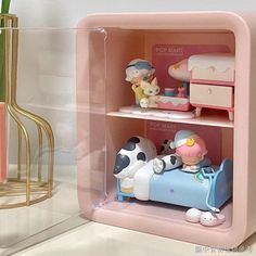 a pink shelf with figurines in it