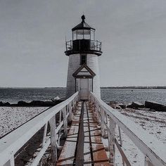 a light house sitting on top of a snow covered beach