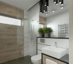 a bathroom with a sink, toilet and shower stall in the middle of it's walls