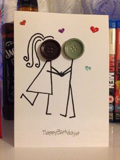 a greeting card with a couple holding hands and two buttons on the front that says happy birthday