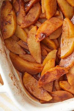 cooked apples in a baking dish on a table