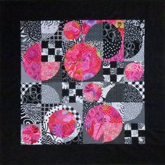 a black and white square with pink flowers on it's side, in the center is