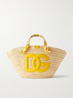 Dolce & Gabbana's 'Kendra' tote celebrates the "ancient ceramics of Caltagirone". It's woven from raffia and detailed with a large leather logo, plus silk-twill wrapped like a scarf around the handles. The joyful design makes it the perfect choice for summer and you'll have plenty of space for your essentials - think phone, wallet and your current book. Ancient Ceramics, Porter Bag, Joyful Design, Raffia Tote Bag, Summer Style Guide, Flat Dress Shoes, Raffia Bag, Silk Twill, Leather Logo