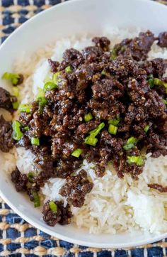 a white bowl filled with rice and meat