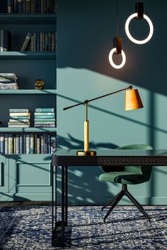 a desk with a lamp on it and bookshelves in the background, along with a bookcase