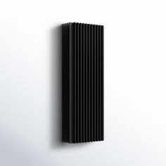 a black radiator is hanging on the wall in front of a white background