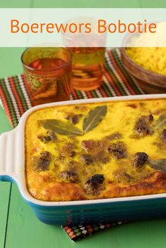 a casserole dish with meat and cheese in it on a green tablecloth