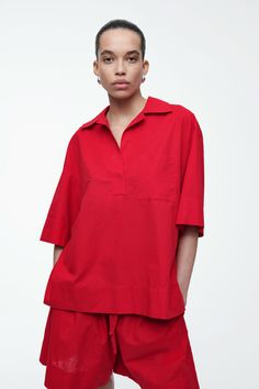 Offered in a vivid red shade that's key for the season, this modern resort shirt is designed with subtle nods to utility – note the oversized patch pocket at the chest. It's crafted from an airy cotton and linen blend and features a camp collar, deep side slits and a stepped hem.  Relaxed fitChest patch pocket Shell: 84% Cotton, 16% Linen. Excluding trims / Machine wash Back length of size 6 is 29.72" / Model wears a size 6 Red Summer Tops With Pockets, Red Polo Collar Shirt For Summer, Red Summer Blouse With Pockets, Red Blouse With Pockets For Summer, Red Collared Blouse With Pockets, Red Collared Blouse With Relaxed Fit, Red Oversized Collared Shirt, Red Collared Tops With Placket, Cos Shorts