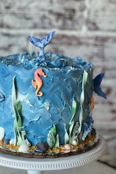 a blue cake with sea animals on it