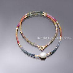 two bracelets with beads and a pearl on the end, one is multicolored