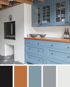 a kitchen with blue cabinets and white walls