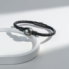 Dive into elegance with our Tahitian Baroque Pearl Leather Bracelet. Featuring a luminous black 12-14mm Tahitian pearl on genuine leather, its unique charm shines through. Adjustable lengths ensure a perfect fit. A modern twist on a timeless classic. Add this gem to your collection today. Bracelet Length: 7.5'' (19cm). 8.5" (21cm) Product Information Pearl Type Tahitian Pearl Origin Tahiti Shape Baroque Quality AAA Size 12-14mm Nacre Very Thick Color Black Luster Very High Luxury Pearl Bracelet With Charm, Elegant Round Adjustable Leather Bracelet, Luxury Round Leather Jewelry, Elegant Silver Leather Bracelet, Elegant Leather Bracelet Jewelry, Elegant Round Leather Jewelry, Elegant Leather Bracelet For Gift, Large Pearl Earrings, Golden South Sea Pearls