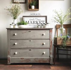 an old dresser with some plants on top