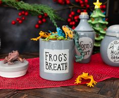 frog's breath mugs on a red placemat with christmas decorations in the background