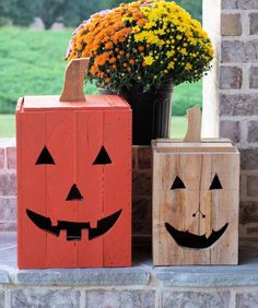 two wooden pumpkins sitting next to each other