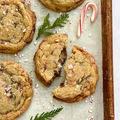 chocolate chip cookies with candy canes and sprinkles on a baking sheet